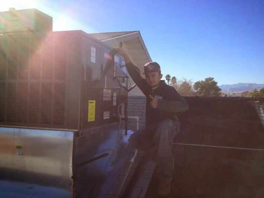HVAC technician performing HVAC Inspection on a rooftop unit in Roseville